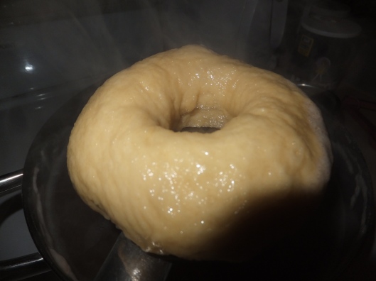 A boiled bagel, ready to bake